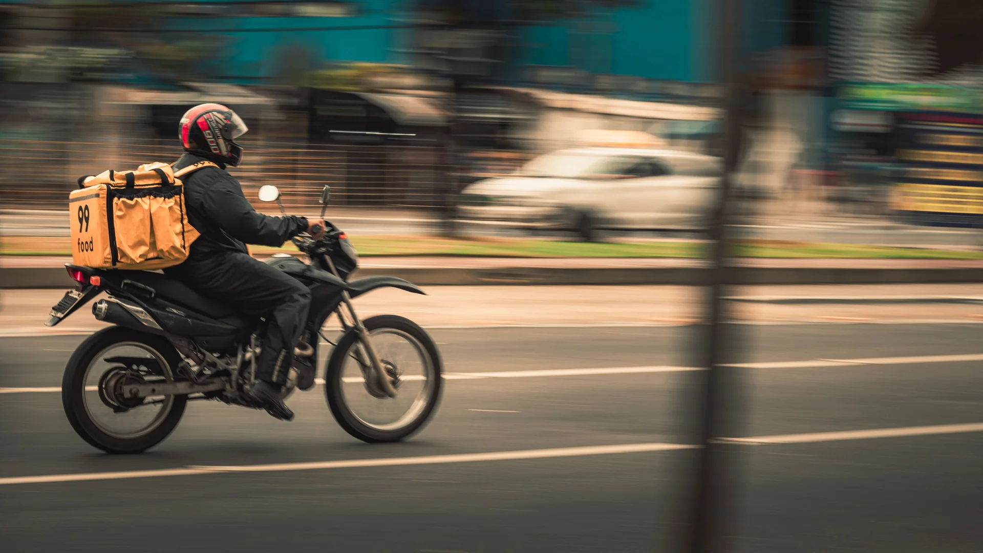 Zebtee delivery rider on a motorcycle courier run through a busy city street